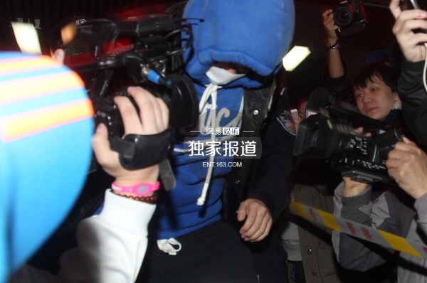 李代沫戴手铐离开派出所。