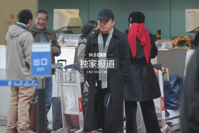 刘欢夫妇表情严肃现身机场 冷色调打扮无交流